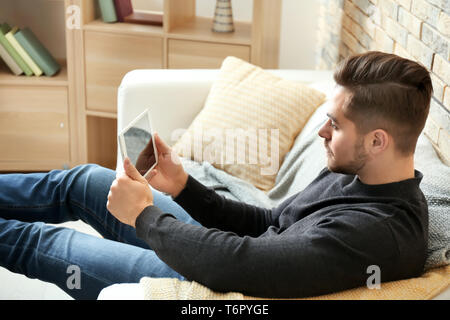 Young man using tablet at home Stock Photo