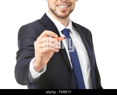 Young businessman writing on virtual screen against white background Stock Photo