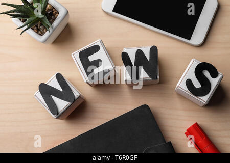 Composition with word NEWS on wooden background Stock Photo