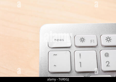 Computer keyboard key with word NEWS on wooden table Stock Photo