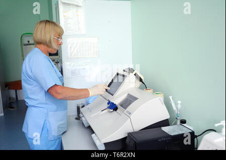 At a hospital laboratory. Lab technician performing analysis of blood samples with gas-electrolyte analyzer. May 18,2018. Kiev,Ukraine Stock Photo