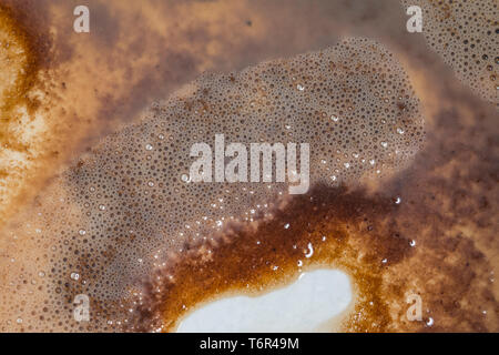 Concept of running out of coffee, showing the grouts in the bottom of a mug from a hot chocolate or coffee drink. Stock Photo