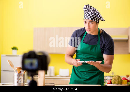 Young chef blogger explaining food preparation Stock Photo