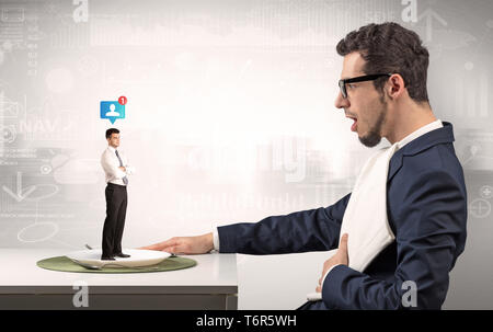 Giant businessman eating small man with financial background  Stock Photo