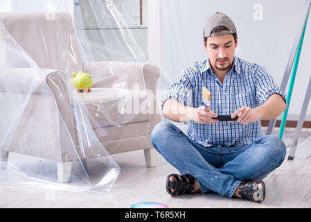 Young man contractor choosing color from rainbow Stock Photo