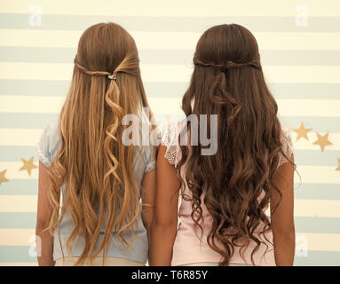 hairdresser salon services. two little girls kids with long hair at  hairdresser. little girls with long curly hair. long and healthy hair.  kertatine mask Stock Photo - Alamy