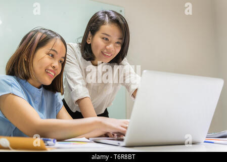 Asian employees working together in a team Stock Photo