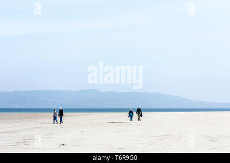 Two senior couples on a beach walking, County Donegal, Ireland Stock Photo