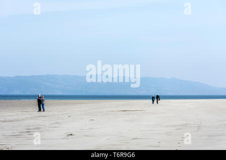 Two senior couples on a beach walking, County Donegal, Ireland Stock Photo