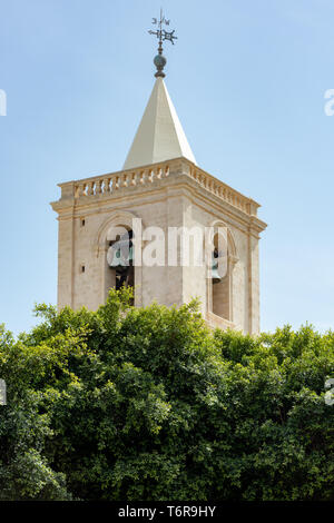 The weather vane and bells of one of the two mannerist styled bell towers of St John's Co-Cathedral in Valletta Stock Photo