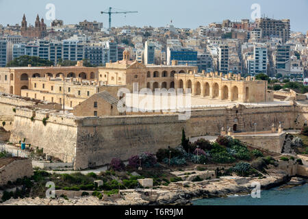 The Historic Fort Manoel with the modern apartment blocks of Sliema in the background. This star fort was built by the Order of St John in the 18th C Stock Photo