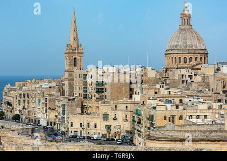 The dome of the Basilica of Our Lady of Mount Carmel and the bell tower of St Paul's Pro-cathedral dominate the view of Valletta's northern shore line Stock Photo