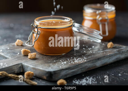 Salted caramel in glass jars. Stock Photo