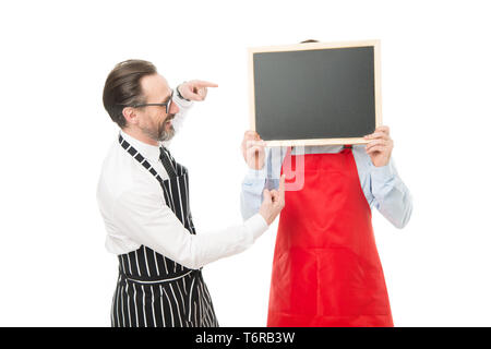 Workers wanted. Hipster bartender show blackboard copy space. Men bearded hipster informing you. Opening soon. Men bearded bartender or cook in apron hold blank chalkboard. Bartender with blackboard. Stock Photo