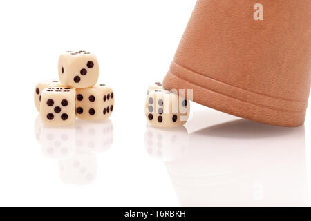 Dices and a gmaing shaker isolated on white background. Gaming, luck and risk concept. Stock Photo