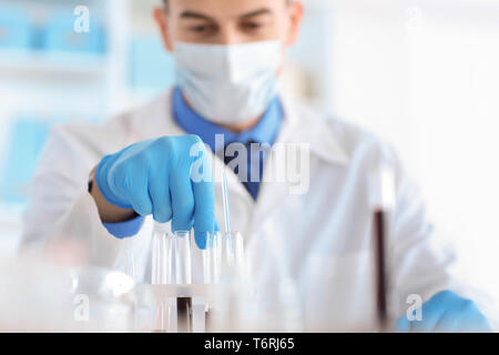 Scientist with test tubes in laboratory Stock Photo