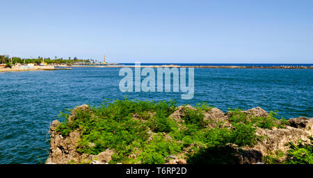 View of the port of Santo Domingo Dominican Republic from Juan Baron square, with beautiful sunny day and blue waters with boats arriving at port Stock Photo