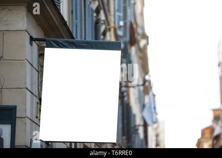 Hanging rectangular blank flag on the street in the city - Image Stock Photo