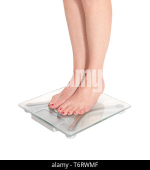 Womans legs standing on a glass scale Stock Photo