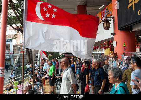 11.08.2018, Singapore, Republic of Singapore, Asia - Elderly people are seen in front of the Chinatown Complex watching a public event. Stock Photo