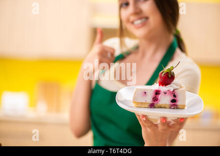 Young cook cooking cakes in the kitchen Stock Photo