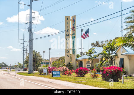 Islamorada, USA - April 30, 2018: Florida Keys sign with yellow blue beach building in village of islands and American flag Stock Photo