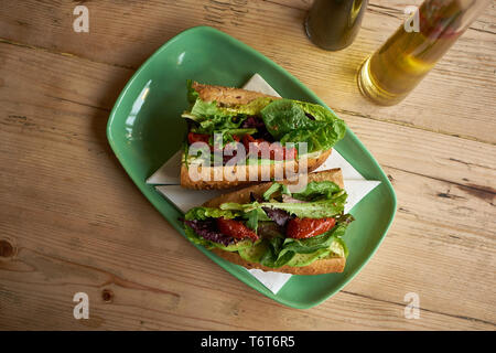 Sundried tomato sandwich on wooden table Stock Photo