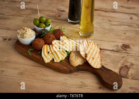 Falafel and Halloumi platter on wood table Stock Photo