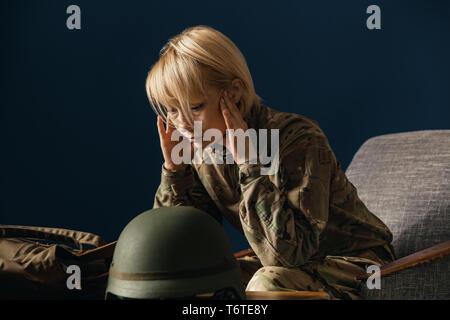 Close up portrait of young female soldier. Woman in military uniform on the war. In doctor's consultation, depressed and having problems with mental health and emotions, PTSD, rehabilitation. Stock Photo