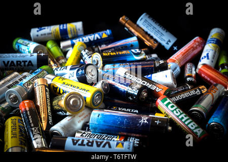 Sibiu, Romania - February 17, 2019. used disposable drain batteries of various size and color on black background Stock Photo