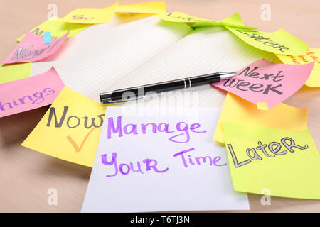 Open notebook and colorful paper notes on table, closeup. Time management concept Stock Photo