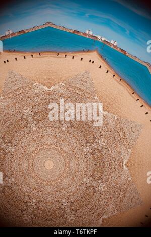 Abstract image created with a kaleidoscope filter. The sandy beach at Southsea, Hampshire. Stock Photo