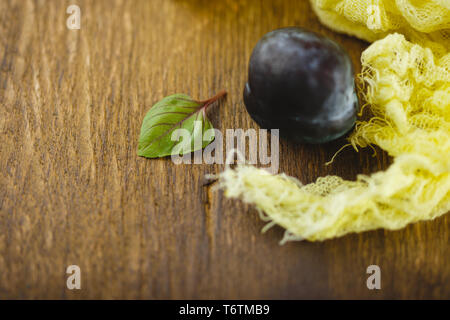 Plums on wooden background Stock Photo