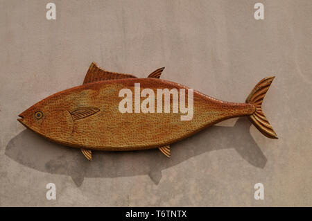 Fish shape of clay on the wall with text space for your logo Stock Photo