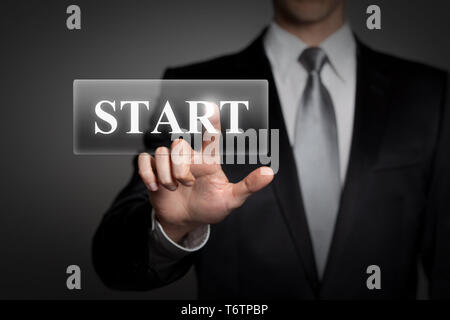 technology, internet, network, business concept - businessman in suit presses virtual touchscreen interface button - english word START Stock Photo