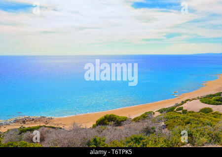 Beautiful empty beach in Turkish Northern Cyprus taken against the sun. The remote place is Golden Beach in Karpas Peninsula. Amazing destination for summer vacation without many tourists. Stock Photo