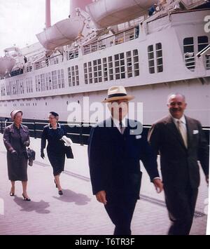 Former President Harry S. Truman, Bess Truman (first lady to President Truman), Mrs. Sam Rosenman, and an unidentified man walking on a pier with a boat in the background at Naples, Florida, June, 1958. Image courtesy National Archives. () Stock Photo