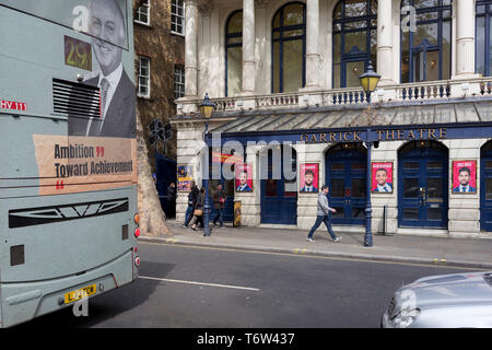 A bus with a rear ad promoting ambition and achievement passes the stars appearing in the Garrick Theatre's current musical 'Rip It Up', on 29th April 2019, in London, England. Stock Photo