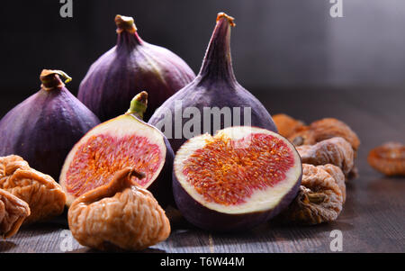 Composition with fresh and dried figs on wooden table. Stock Photo