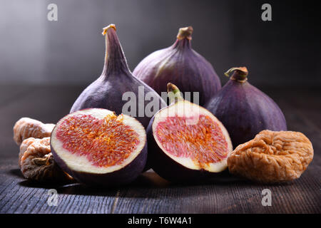 Composition with fresh and dried figs on wooden table. Stock Photo
