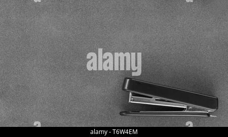 Stapler on dark background top view Stock Photo