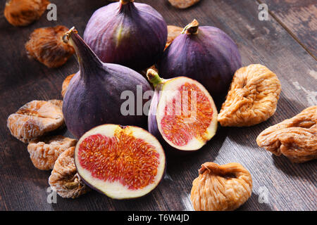 Composition with fresh and dried figs on wooden table. Stock Photo