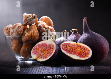 Composition with fresh and dried figs on wooden table. Stock Photo