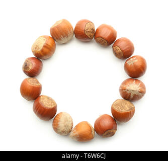 Frame made of tasty hazelnuts on white background Stock Photo