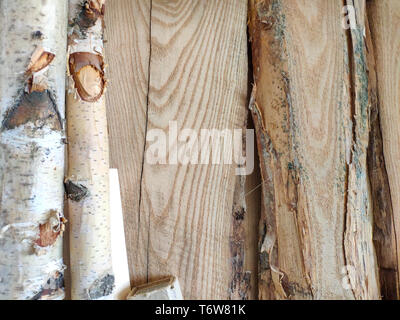 Wooden pillars and thick boards in the furniture workshop are ready to work joiner, soft focus Stock Photo