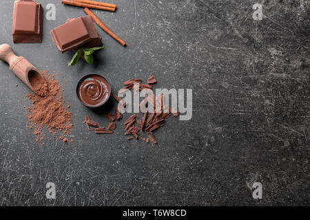 Composition with tasty melted chocolate on grey background Stock Photo
