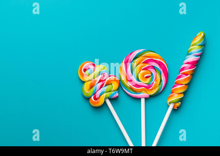 Various colorful lollipops on blue background. Stock Photo