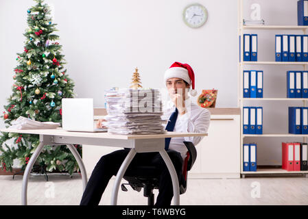 Young worker working in office on christmas shift Stock Photo