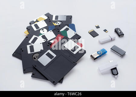 The evolution of digital data storage device. Floppy disks, flash drives and memory cards isolated on a white background. Modern and retro technology. Stock Photo