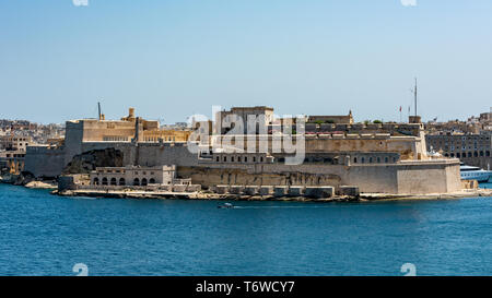 The imposing limestone fortifications of Fort St Angelo overlooking Valletta's Grand Harbour Stock Photo